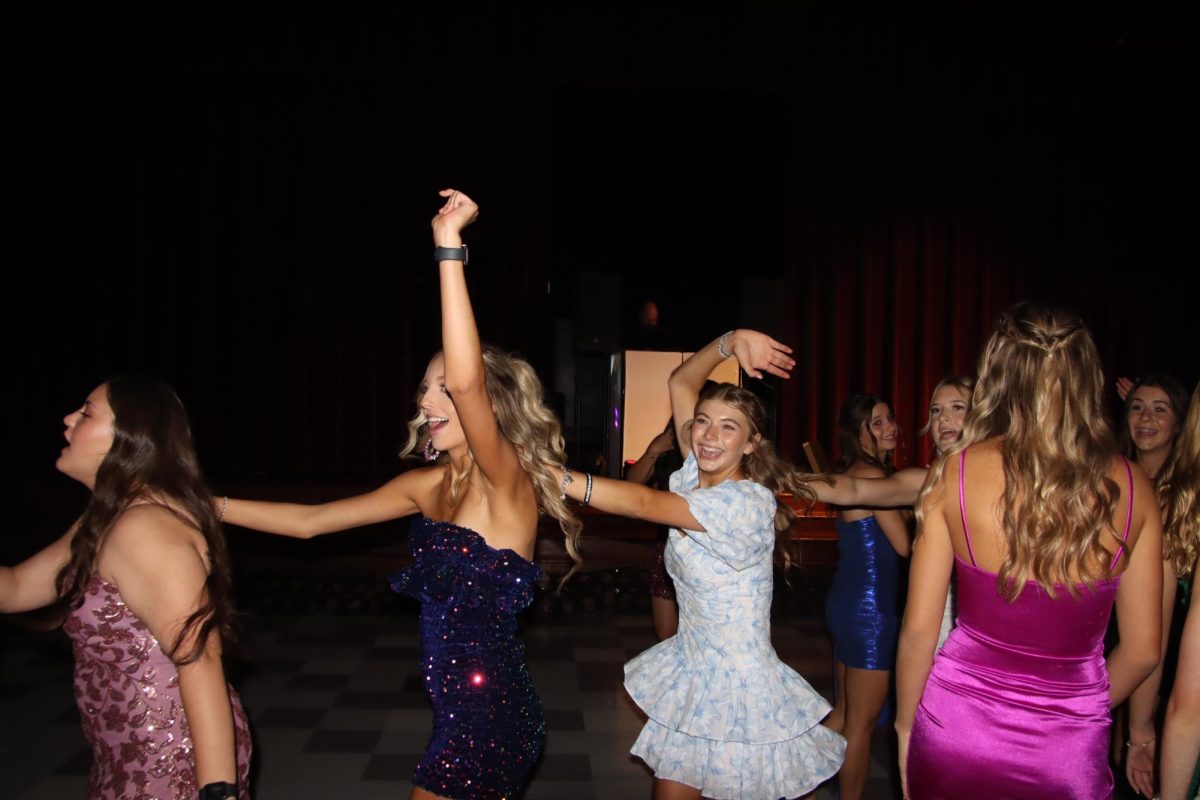 Elle Maes (12), Darby Phillips (11) and Payton Mathison(11) dancing in the conga line during the HOCO dance Saturday, October 5, 2024 in the Hallettsville High School cafeteria. Photo taken by Aidan Vollmar.