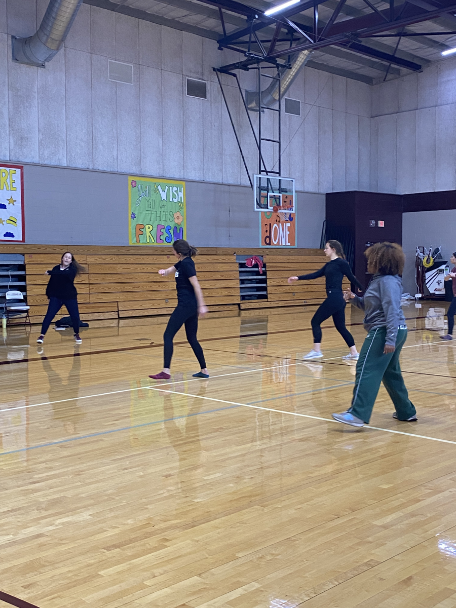 Dance Instructor, Mrs. Bivins leading her students into new moves to add to their dance.