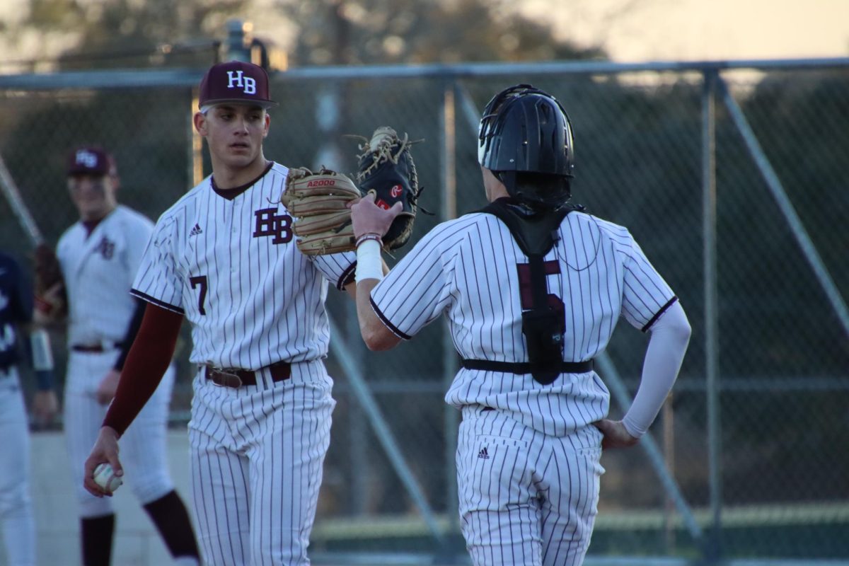 Seniors Carter Blaha (5) and Andrew George (7) on the field