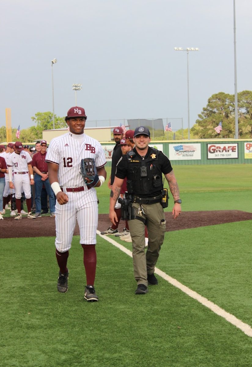 Senior Jorian Wilson walks with veteran Zane Blaha before the game.
