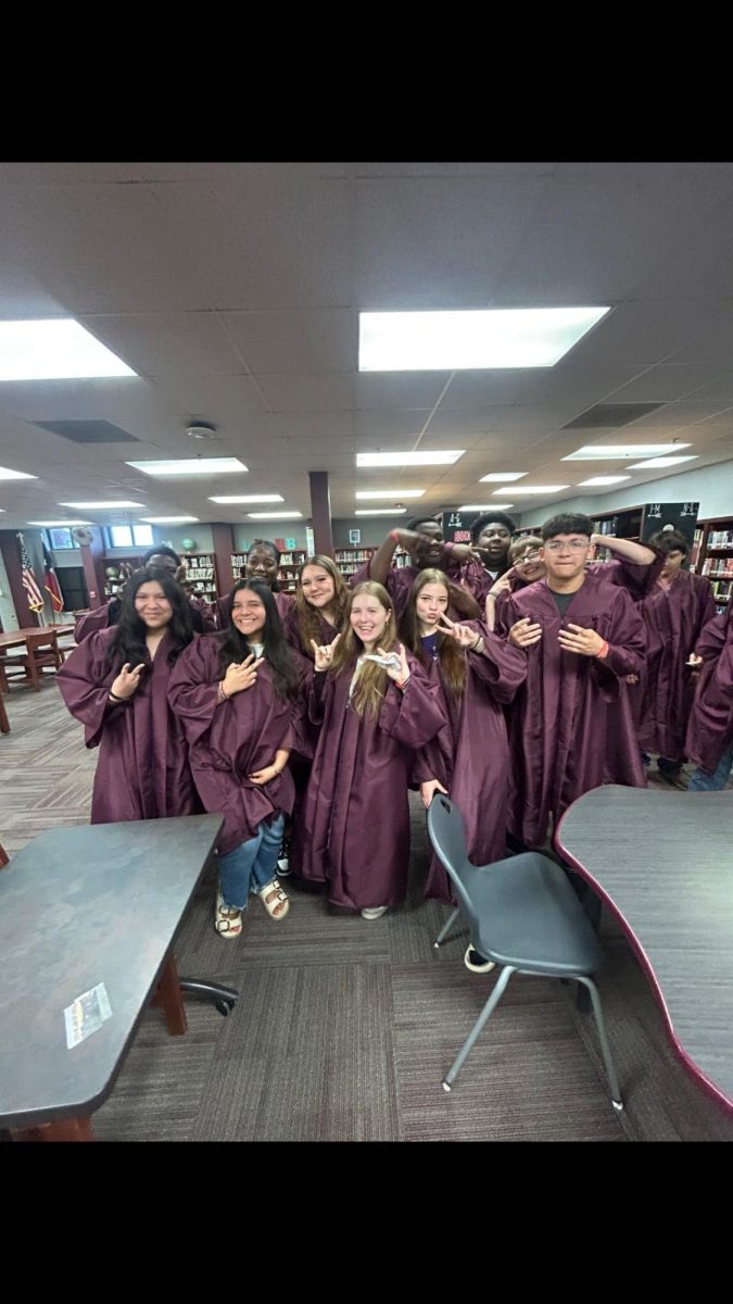 Seniors celebrate in their cap and gowns before their last walk. 