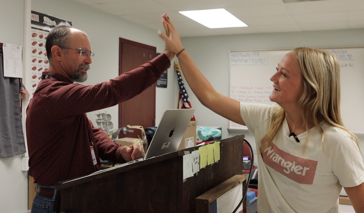 Senior Alyssa Smith high-fives Mr Ressler.